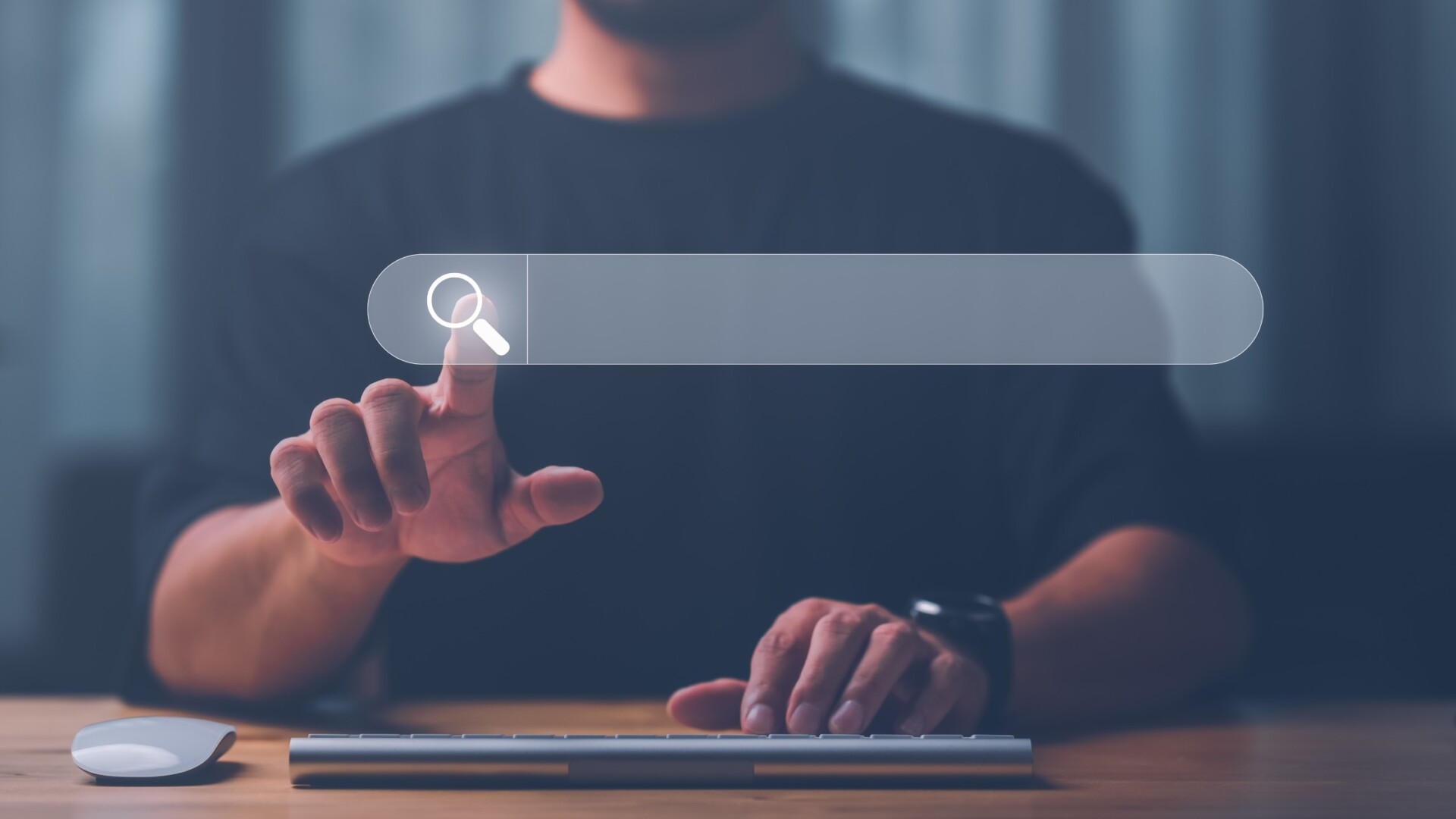 Man's hands typing on a computer keyboard while using Search Console to find information for a website.